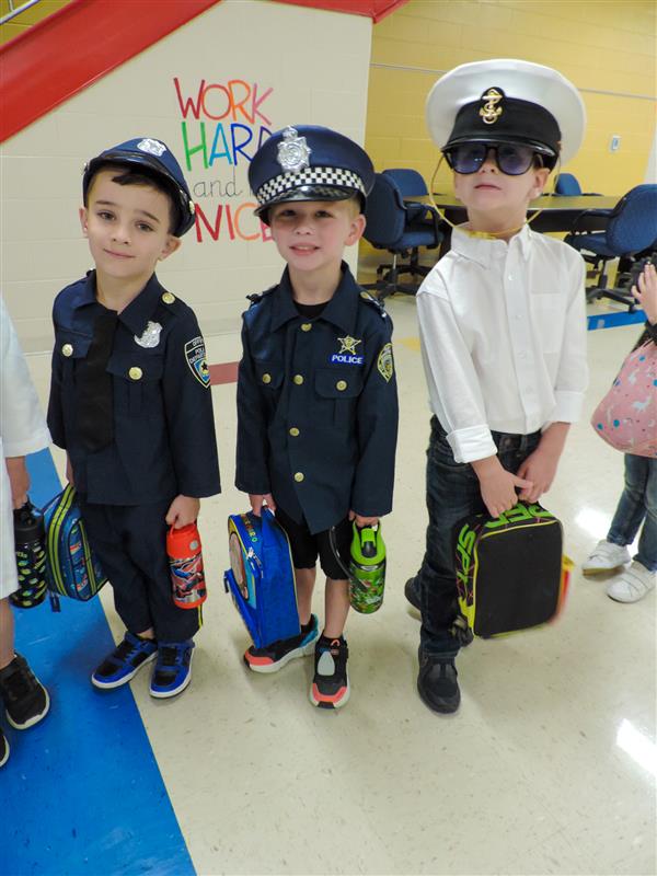 three boys in cop costumes